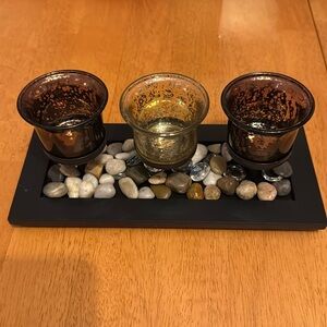 3 votive candle holder. Brown and tan holders and red holders. Stones on bottom